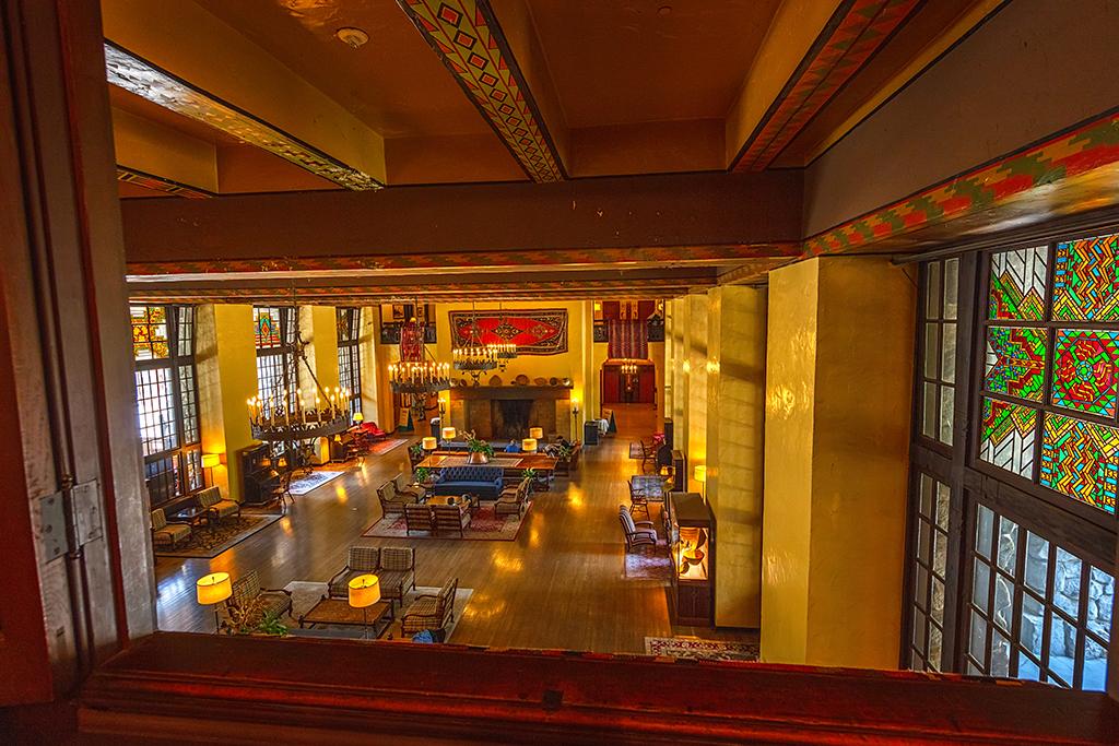 An upper-story view of the warmly-lit lobby at the Ahwahnee Hotel in Yosemite National Park
