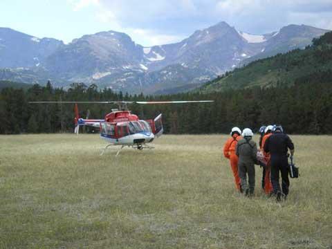 Patient being carried to helicopter