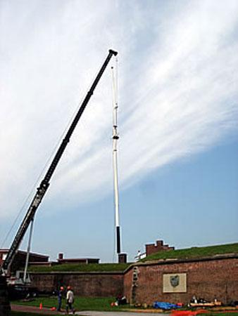 The new 87-foot flagpole being installed. NPS photo by Benjamin Kreshtool.