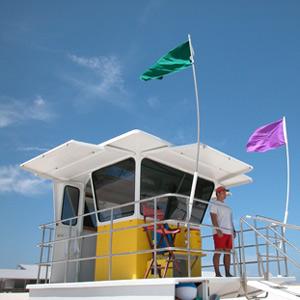 A National Park Service lifeguard watches visitors; NPS Photo