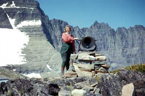 Woman next to bell on Piegan Pass in 1942.