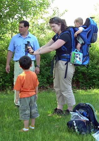 Parents with kids and backpack.