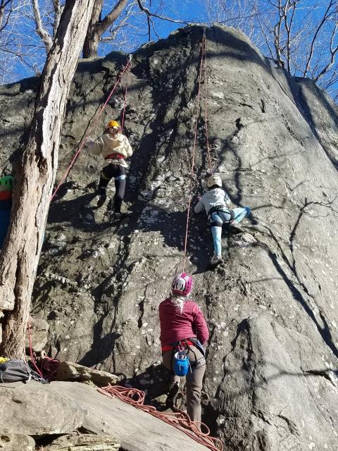 A woman climber leads Girl Scouts at Carderock 