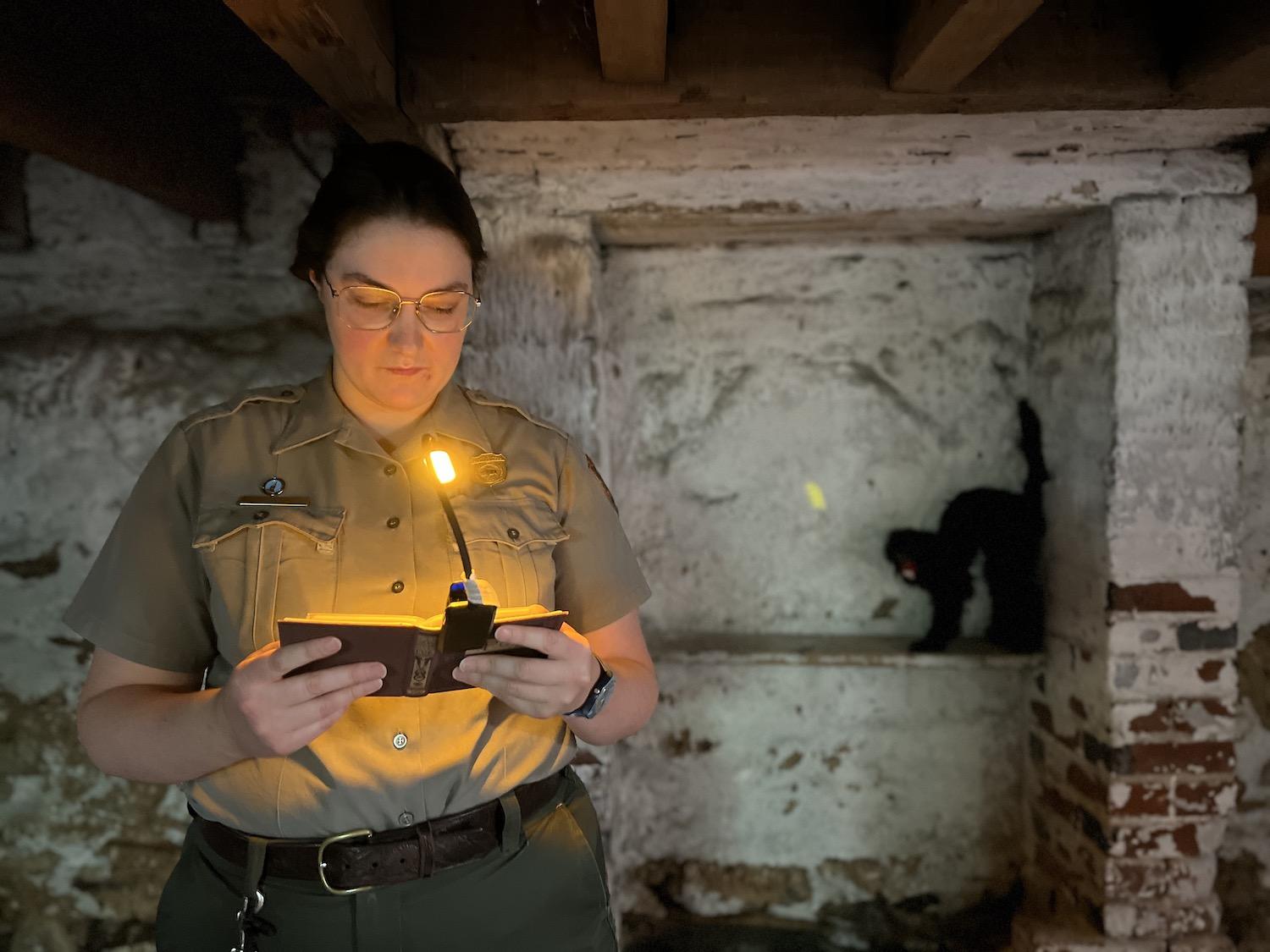 Ranger Sarah Bachan reads "The Black Cat" in the cellar at Edgar Allan Poe National Historic Site.