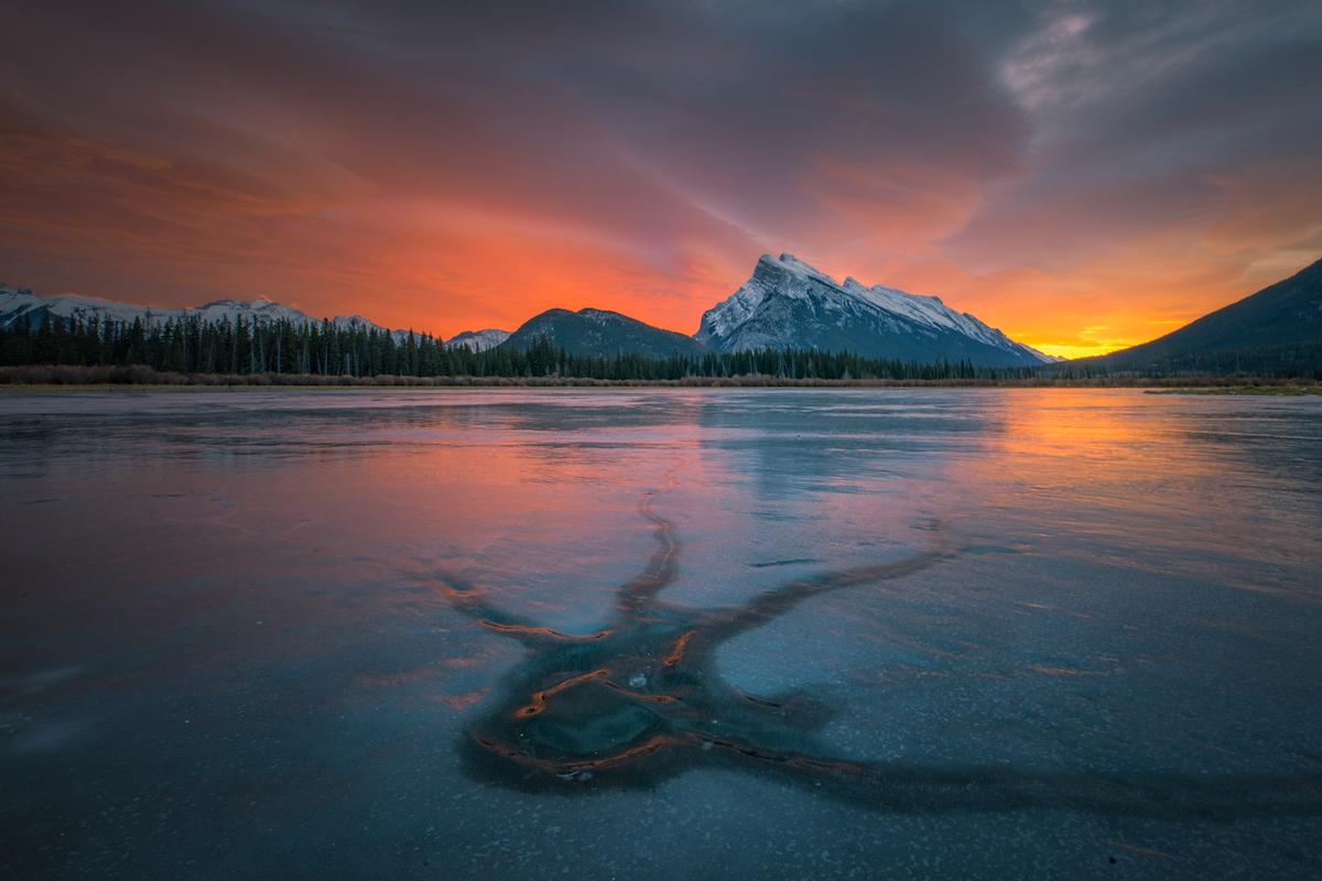 A unique pattern in the wild ice at Vermilion Lakes with Mount Rundle in the backdrop.