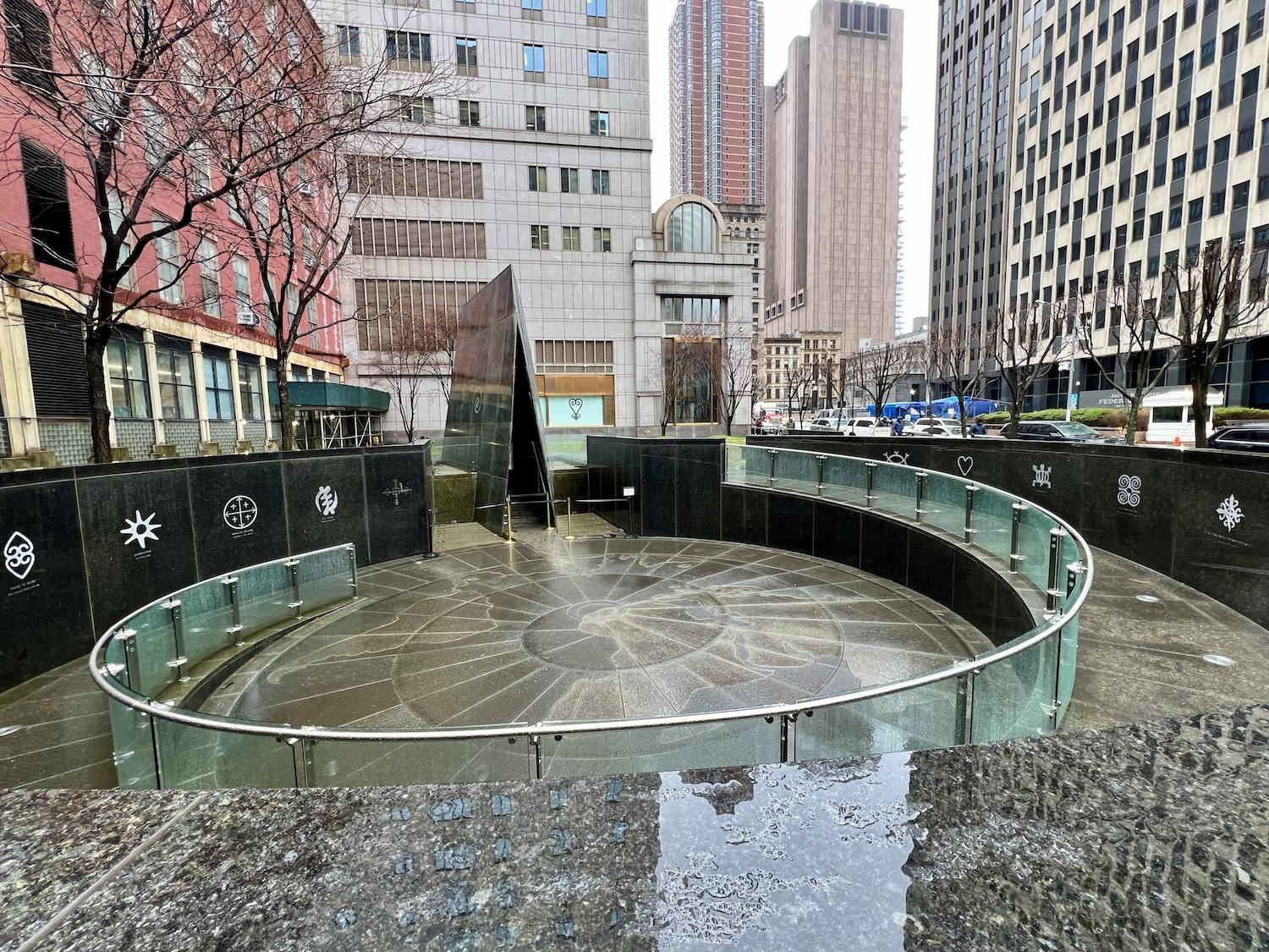 The outdoor portion of African Burial Ground National Monument in Manhattan is outdoors and includes the Ancestral Libation Chamber and the Ancestral Reinterment Ground.