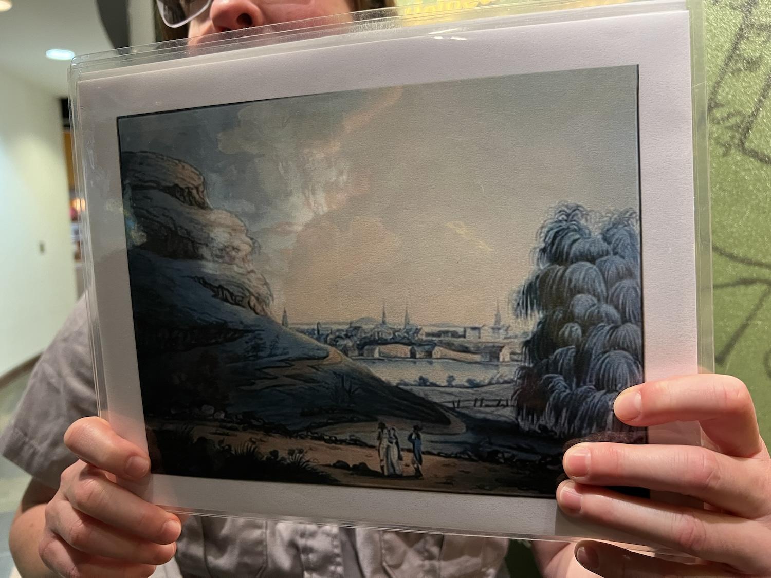 Ranger Bethany Burnett shows a 1798 image of how Manhattan looked when it was a hilly wilderness with a large lake.