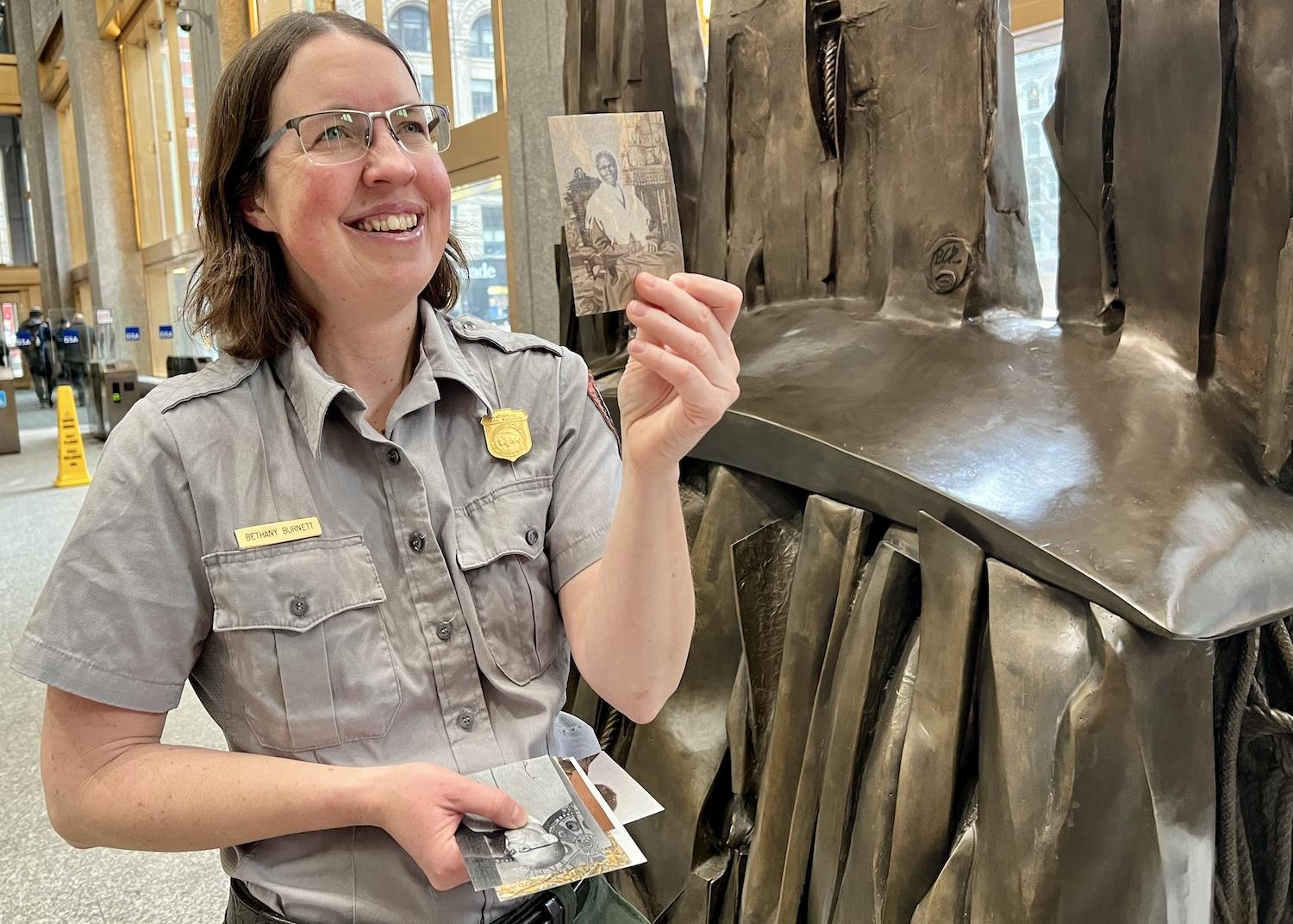 Ranger Bethany Burnett stands by a sculpture called Africa Rising in the Ted Weiss Federal Building lobby.
