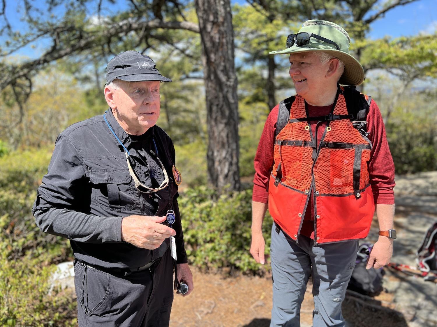 Volunteer ridge runners Bill Dawson, left, and Clive Hillyard, right, chat with each other.