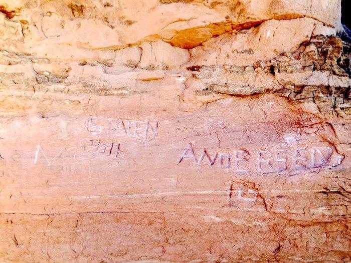 Graffiti carved into sandstone at Arches National Park