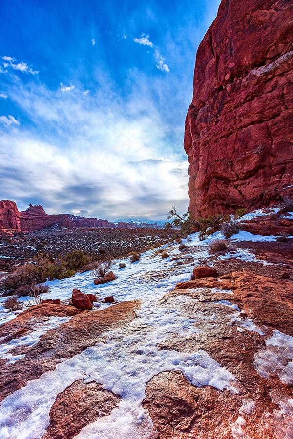 An icy sheen on red rock, Arches National Park / Rebecca Latson