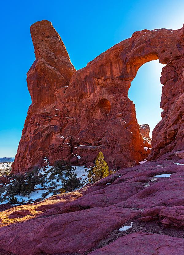 Late afternoon light through Turret Arch, Arches National Park / Rebecca Latson
