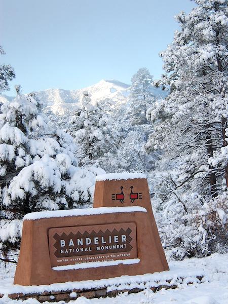 Bandelier National Monument entrance sign in winter/NPS