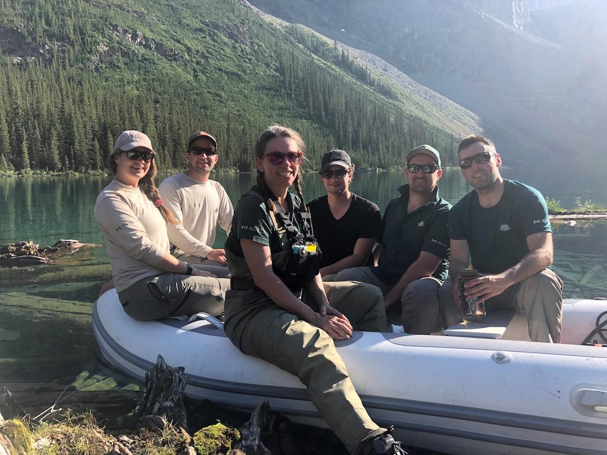 Aquatic specialist Shelley Humphries, center, and the Parks Canada team at Hidden Lake in 2022.