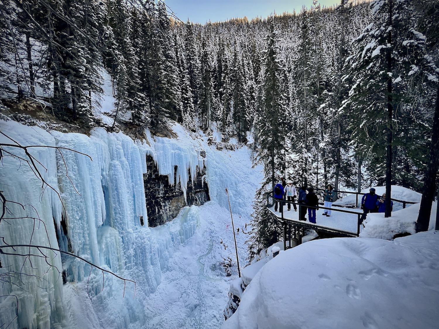 People gather on the viewing platform at Johnston Canyon's Upper Falls.