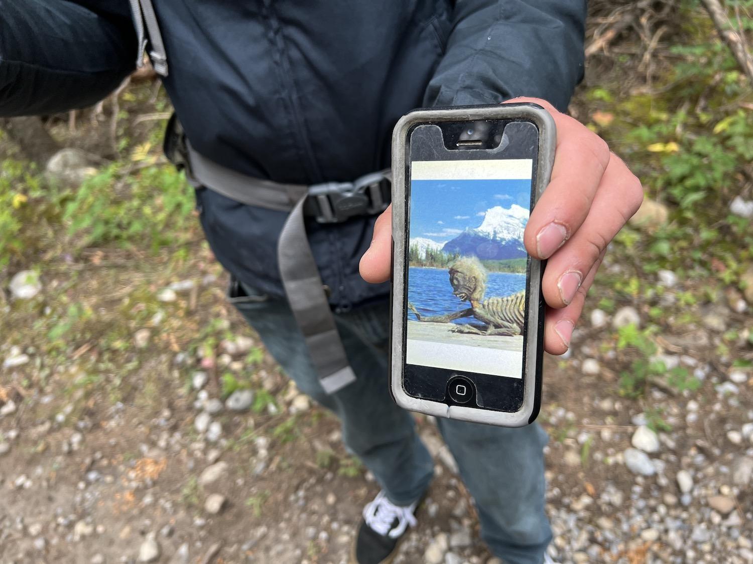 Jordan Ede shows a photo of the "merman," a fabricated monster said to live in Lake Minnewanka.