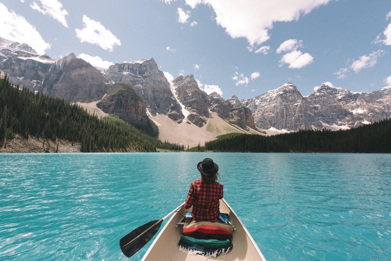 A solo canoeist on Moraine Lake in Banff National Park.