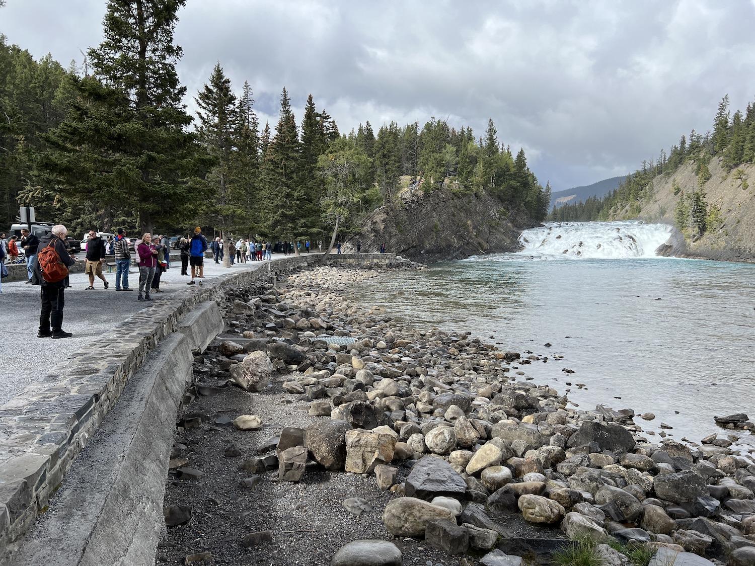 A crowd admires the Bow River in Banff National Park.