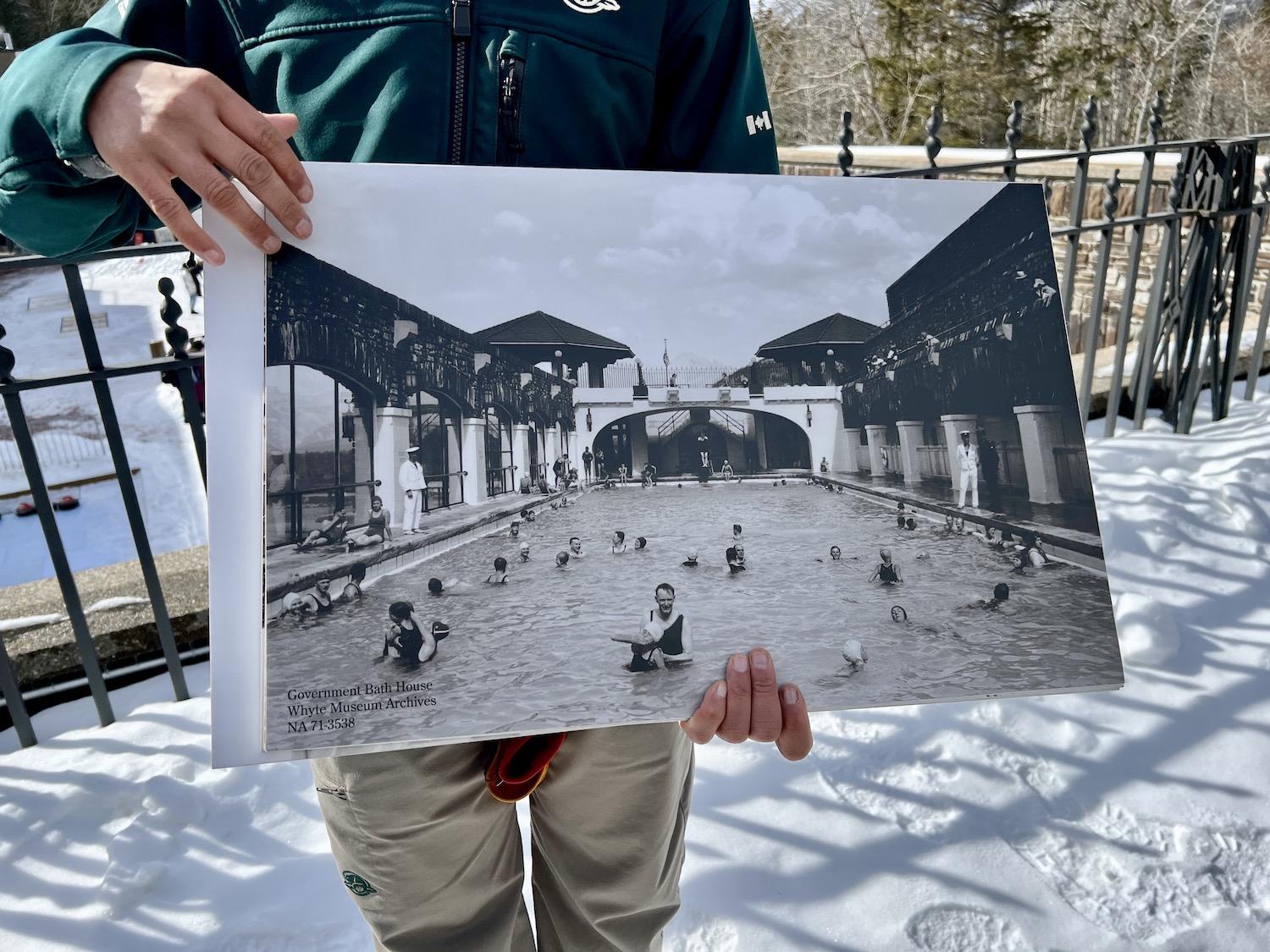 Amar Athwal shows a vintage photo of people swimming at what's now Cave and Basin National Historic Site.