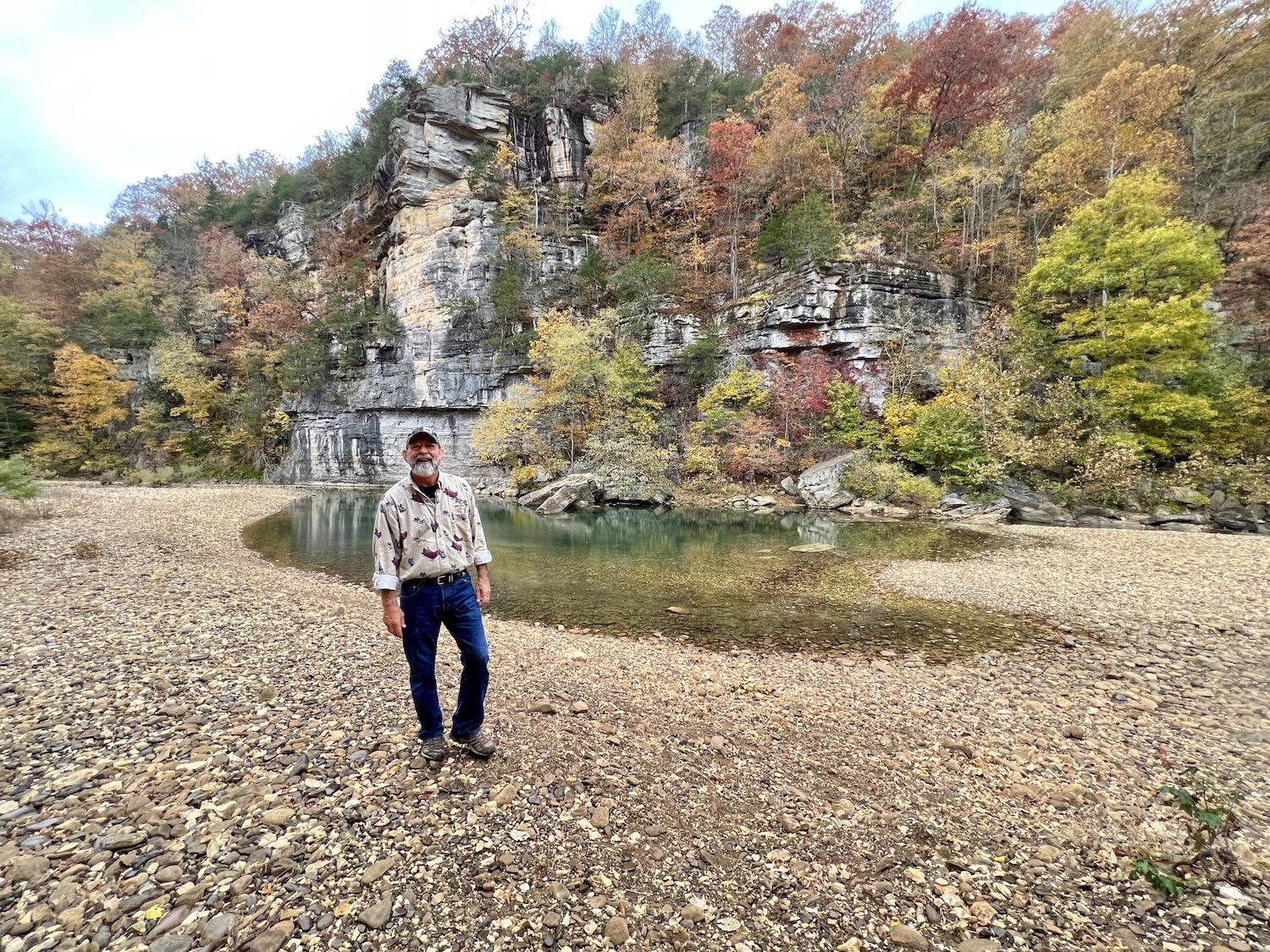 Buffalo Outdoor Center founder Mike Mills stands by the water near Steel Creek Campground in the Buffalo National River.
