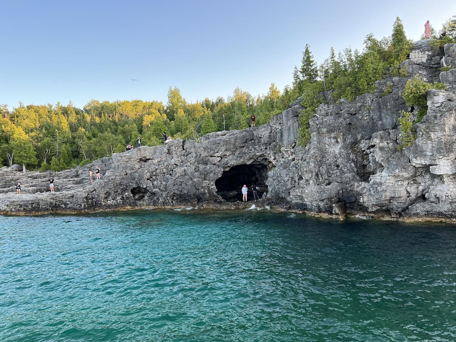 Another view from the sunset cruise of people exploring the Grotto area of Bruce Peninsula National Park.
