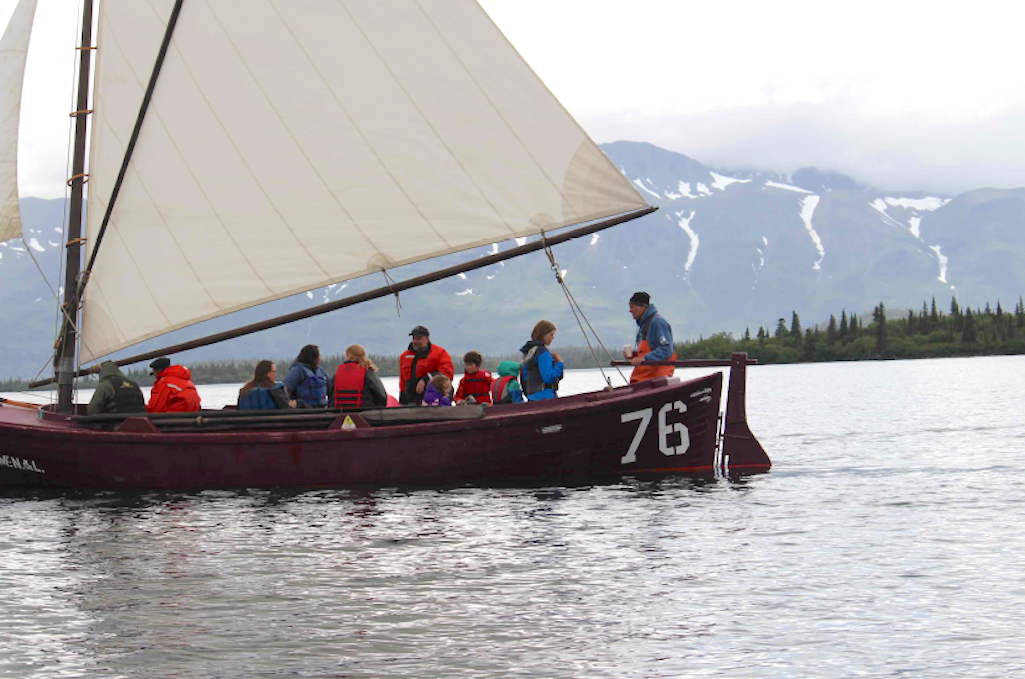 A crew of shipwrights and historians sail a restored sailboat from a mobile maritime history object used to tell the century-old story of the Bristol Bay commercial fishery in Port Alsworth, Alaska. Tim Troll, Bristol Bay Heritage Land Trust