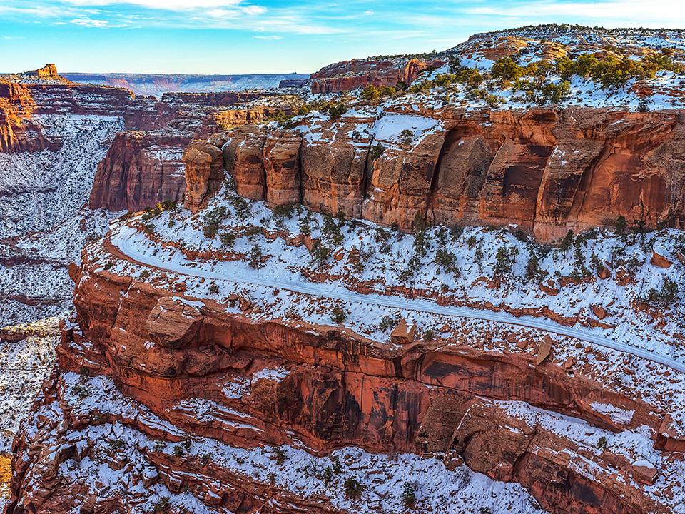 A snowy Shafer Canyon and road, Canyonlands National Park / Rebecca Latson