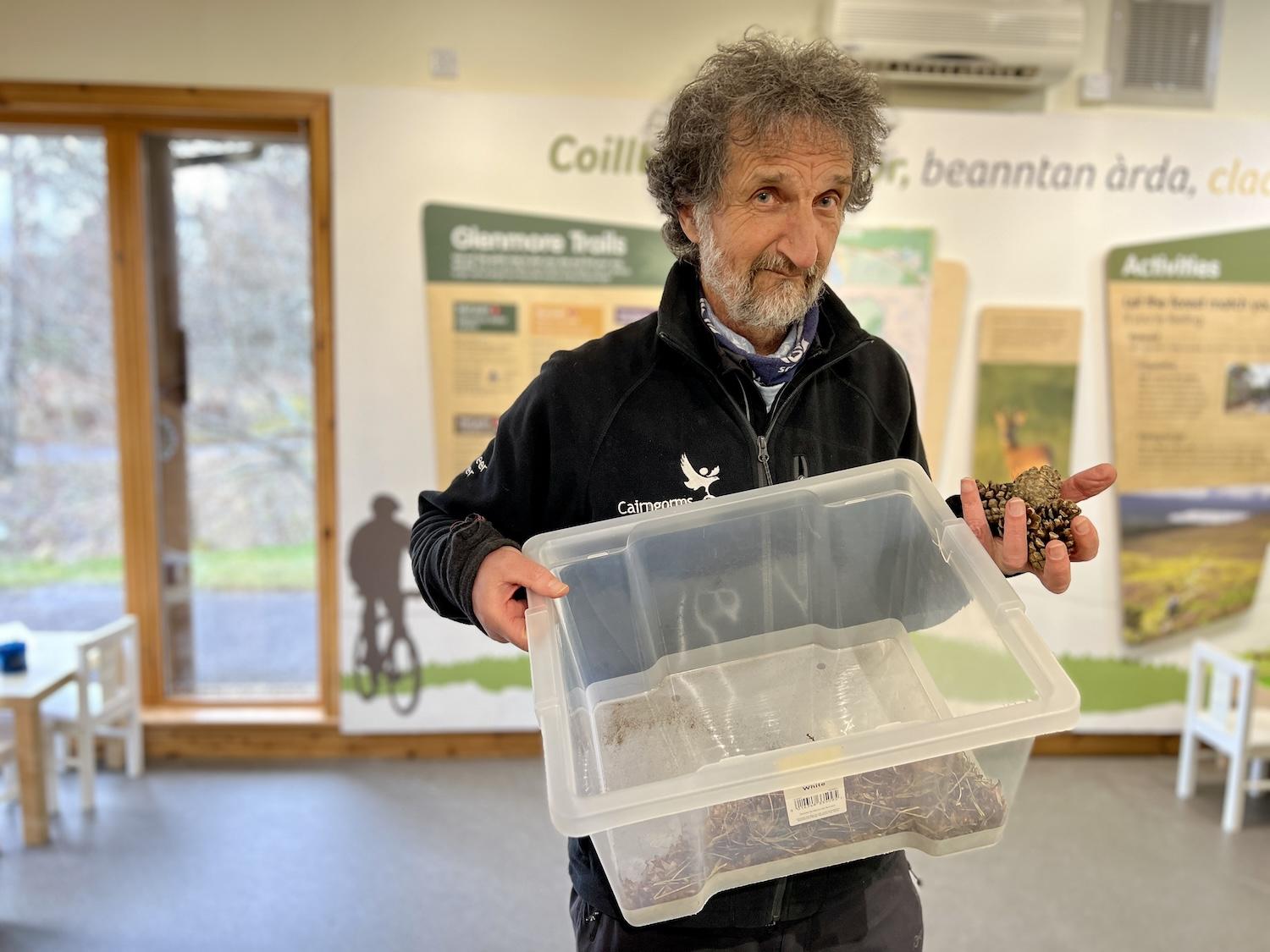 Volunteer ranger Robin Forest separates seeds from pine cones in the Glenmore Visitor Centre.