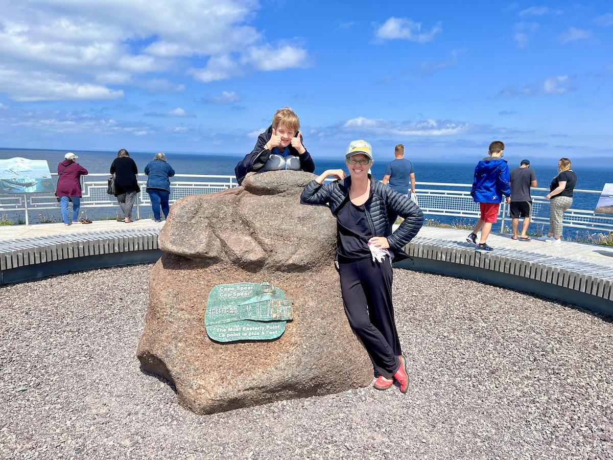 Writer Jennifer Bain and her son pose at the rock that marks Canada's most easterly point.