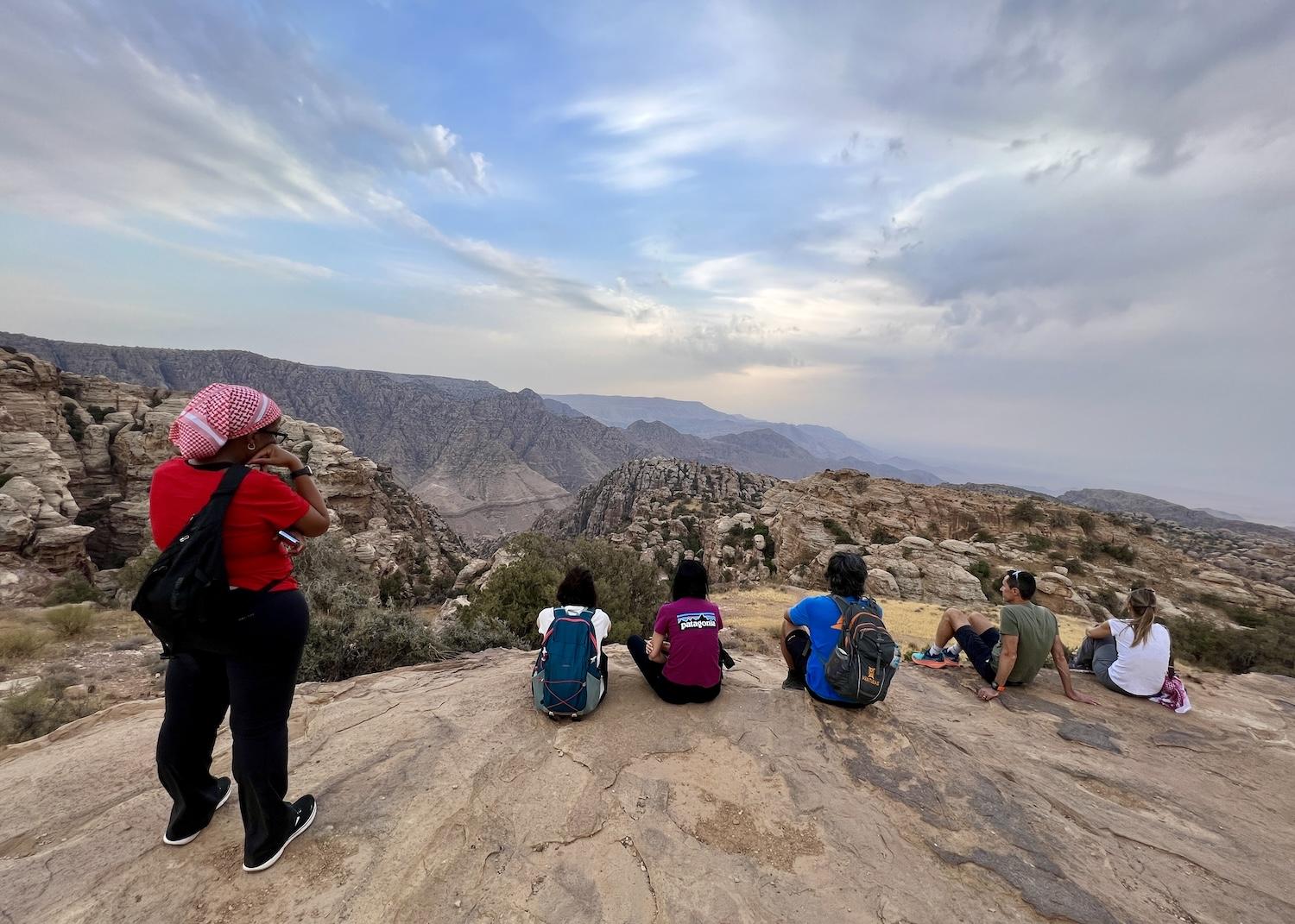Along the Rummana Campsite Trail in Dana Biosphere Reserve, hikers pause to reflect on the Jordanian landscape.