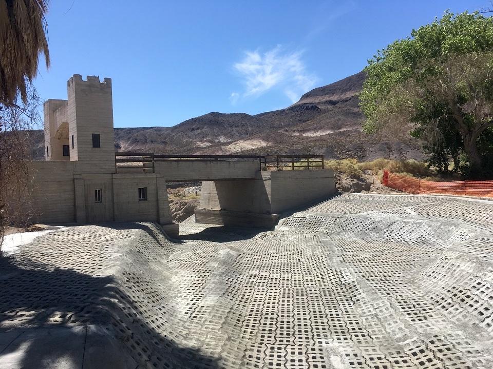 The area in the photo was nearly level before the flood scoured down about 8 feet in depth. Articulated concrete block was installed to prevent future down-cutting, and risk to the bridge foundation/NPS