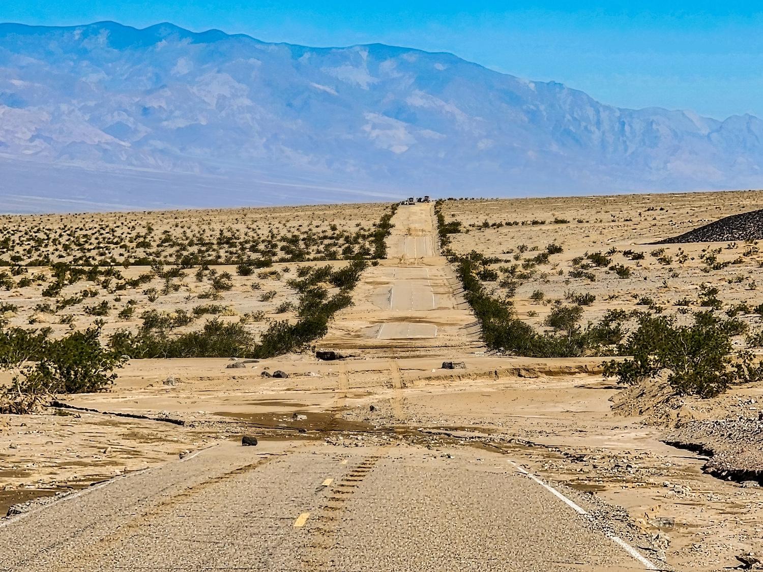Racing down the steep slopes of the Amargosa Range, floodwaters roared across every low point on Badwater Road south of Furnace Creek, California, in Death Valley National Park.