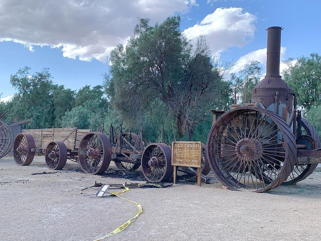 Old Dinah, an old steam engine that replaced the Twenty Mule Teams of the late 1800s is seen with the historic wooden borax wagon that was burned on April 4, 2024/NPS