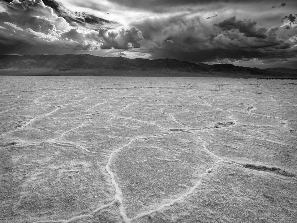 An oncoming storm over Badwater Basin in black-and-white, Death Valley National Park / Rebecca Latson