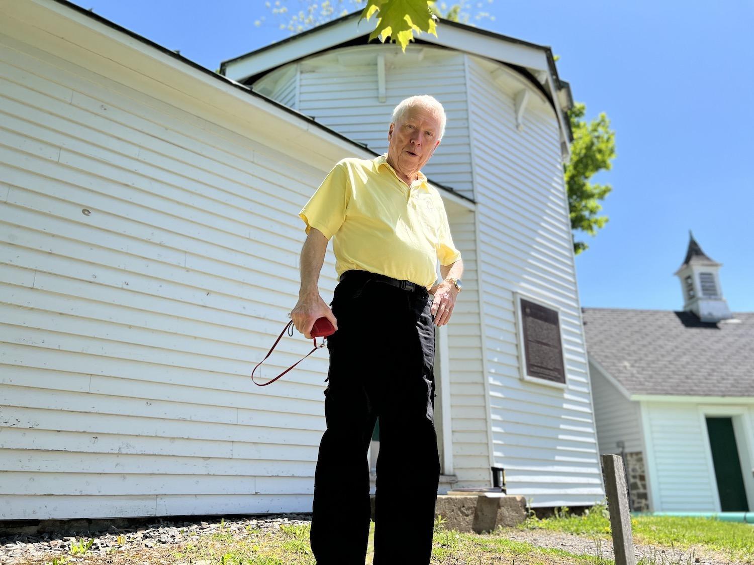 Don Kelly stands before the William Brydone Jack Observatory on the University of New Brunswick campus in Fredericton.