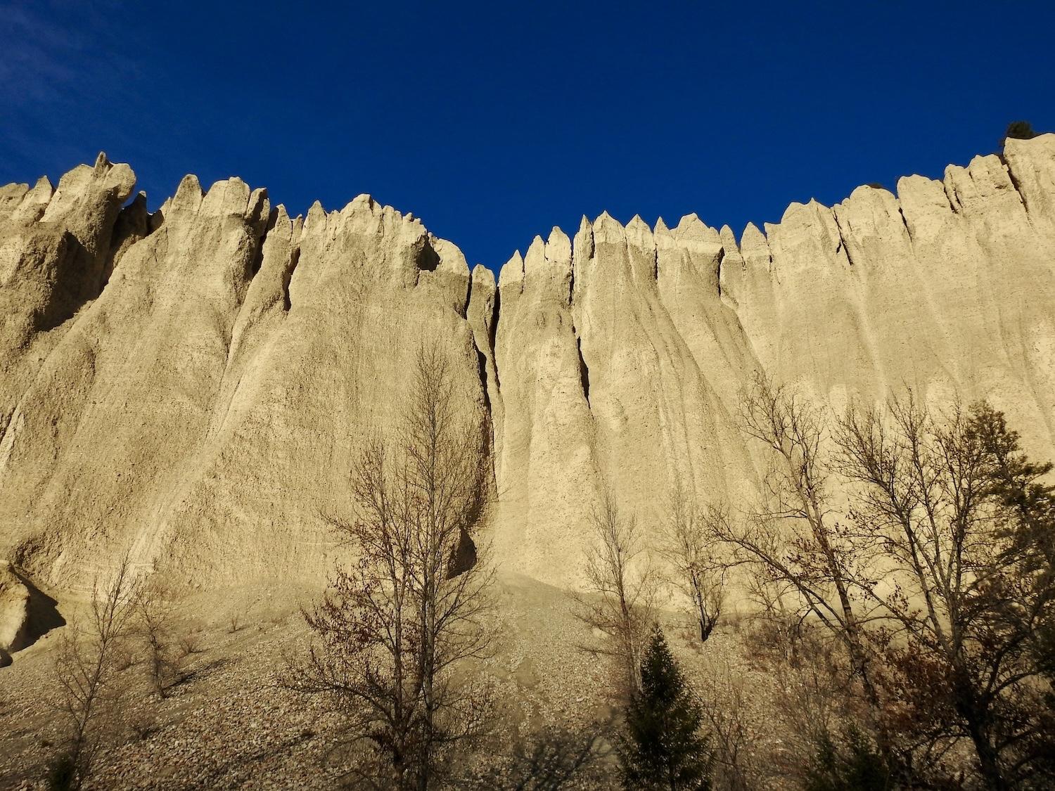 After hiking to the top of the Dutch Creek Hoodoos Conservation Area, view the eroded sandstone cliffs from the highway below.