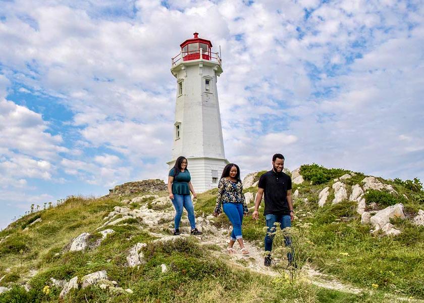 Three people explore the Fortress of Louisbourg National Historic Site in Nova Scotia.
