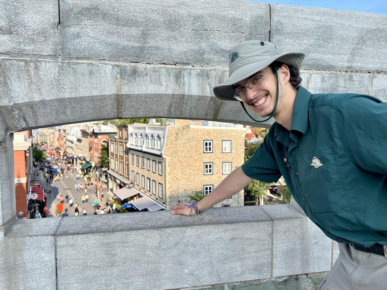 Parks Canada student guide Jacob Murray leads a walking tour of the Fortifications of Québec National Historic Site and shows a spot in Saint-Jean gate that overlooks a busy street.