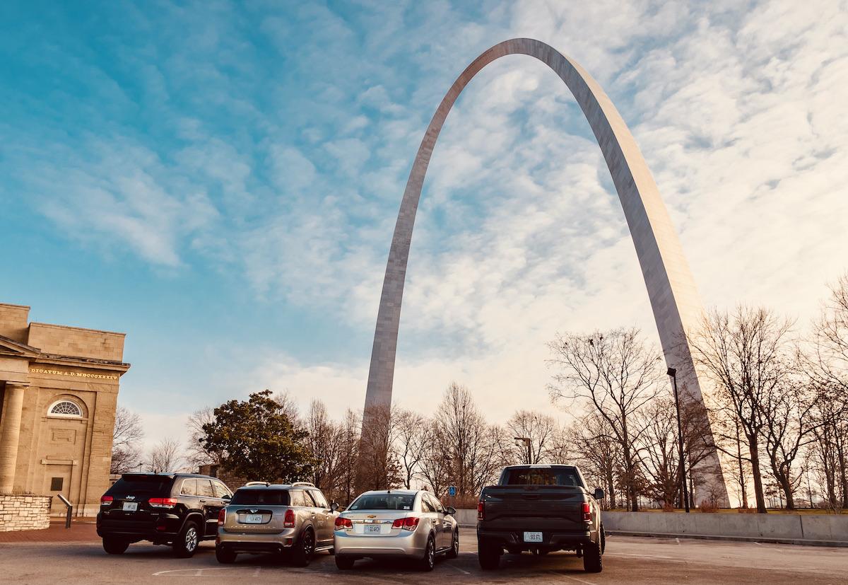 Four cars with custom license plates under the arch at Gateway Arch National Park. Four cars with custom license plates under the arch at Gateway Arch National Park.