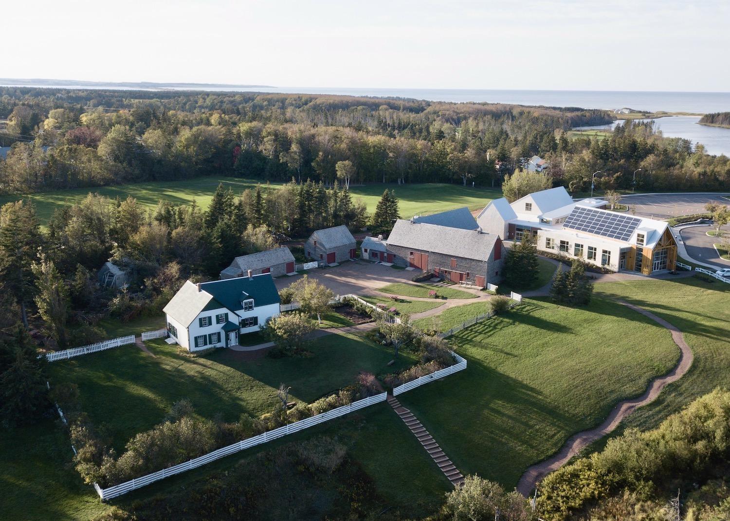 A drone captures an overview of Green Gables Heritage Place in Prince Edward Island, a site that celebrates author L.M. Montgomery and her Anne of Green Gables book series.