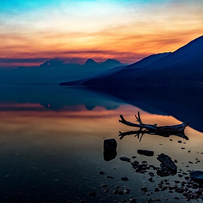 A forest fire sunrise over Lake McDonald, Glacier National Park / Rebecca Latson