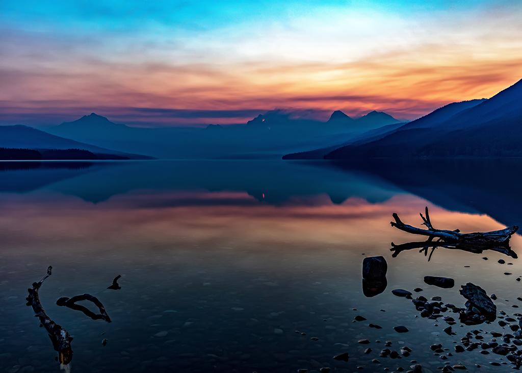 A forest fire sunrise at Lake McDonald, Glacier National Park / Rebecca Latson