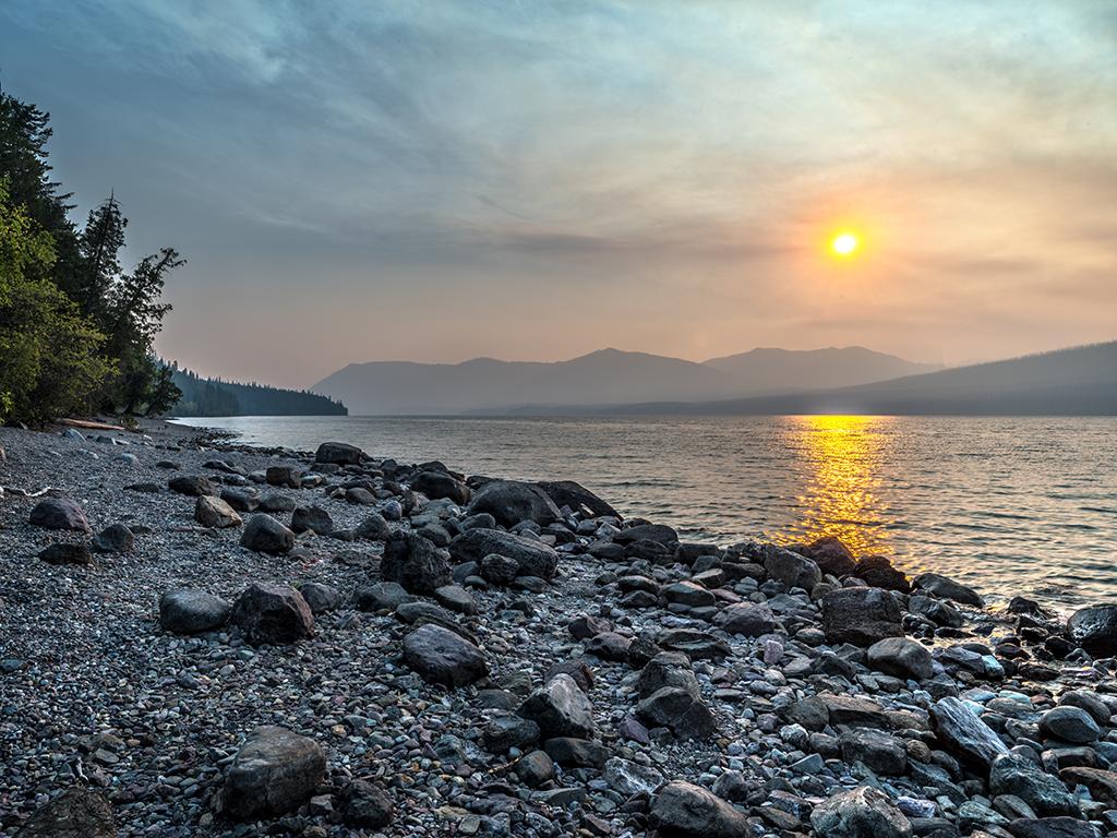 The beginning of a wildfire sunset over Lake McDonald, Glacier National Park / Rebecca Latson