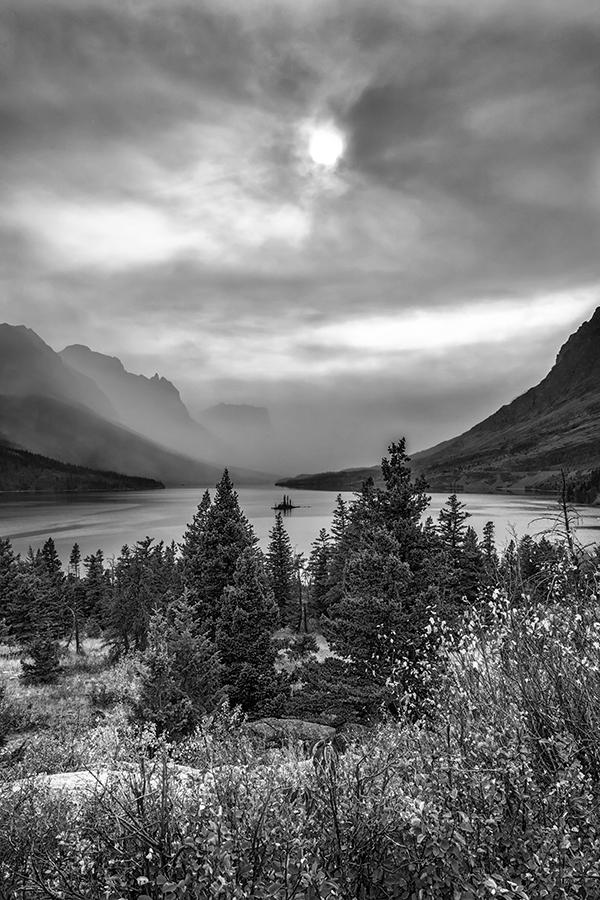A smoky late-afternoon view of Saint Mary Lake in monochrome, Glacier National Park / Rebecca Latson