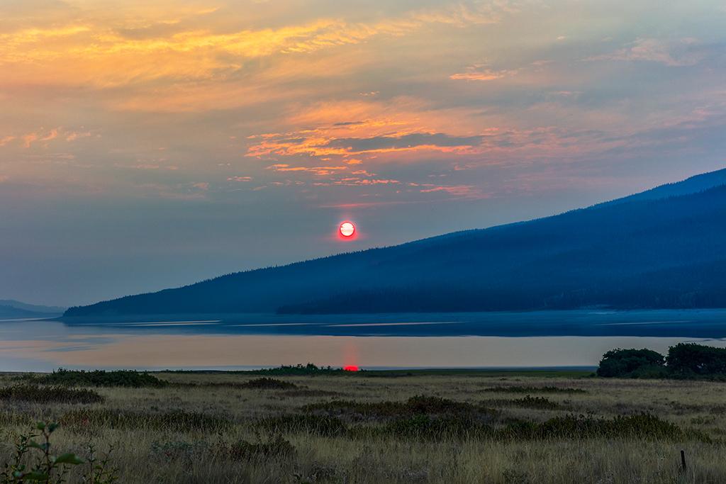 A smoky sunrise over Lake Sherburne, Glacier National Park / Rebecca Latson