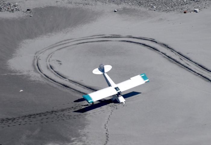 Plane mired in muck at base of Grand Pacific Glacier in Glacier National Park/NPS