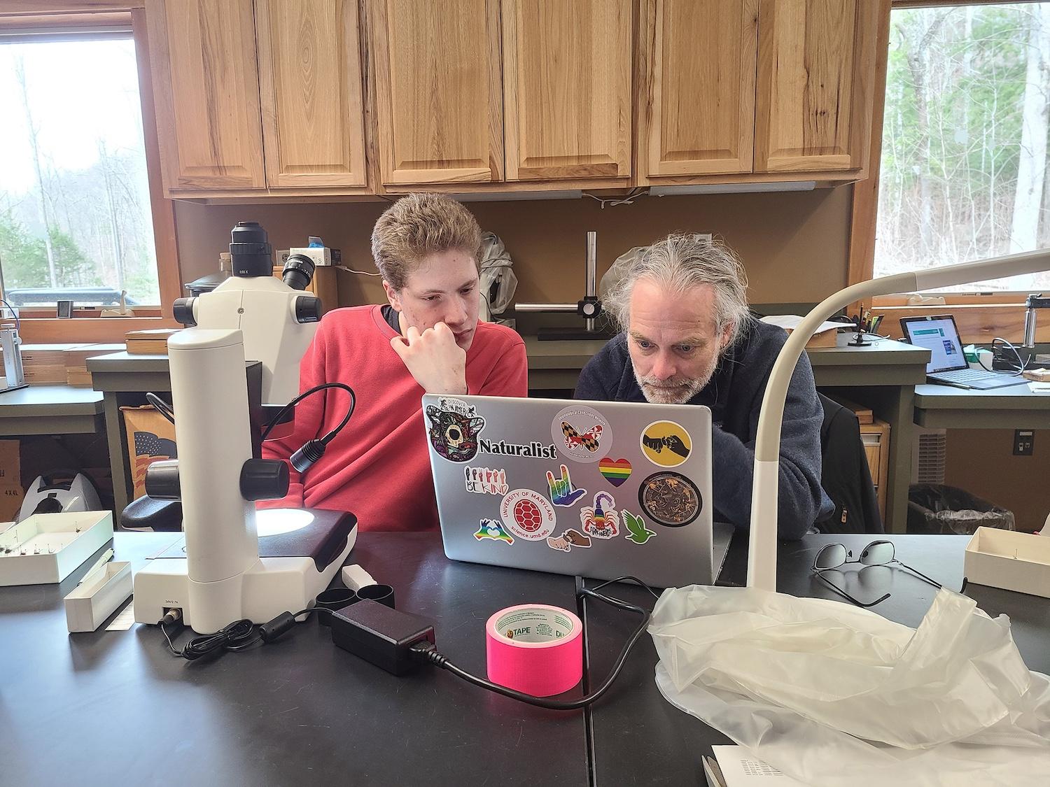 Zachary Dankowicz and Bradley Sinclair work together to identify a perplexing Lepidodexia hirculus specimen during the Fly ID Blitz, held March 1–3 at the Twin Creeks Science and Education Center in Great Smoky Mountains National Park/DLIA