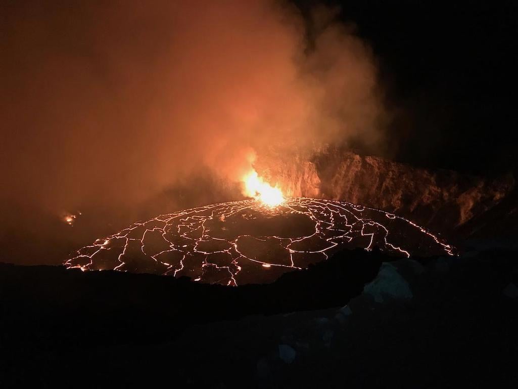 An early December 25, 2020, morning view of the ongoing eruption in Halema‘uma‘u crater at Kīlauea's summit. Overnight fountaining continued to feed the rising lava lake, which slowly fills Halema‘uma‘u. This photo, taken at approximately 2:30 a.m. from t