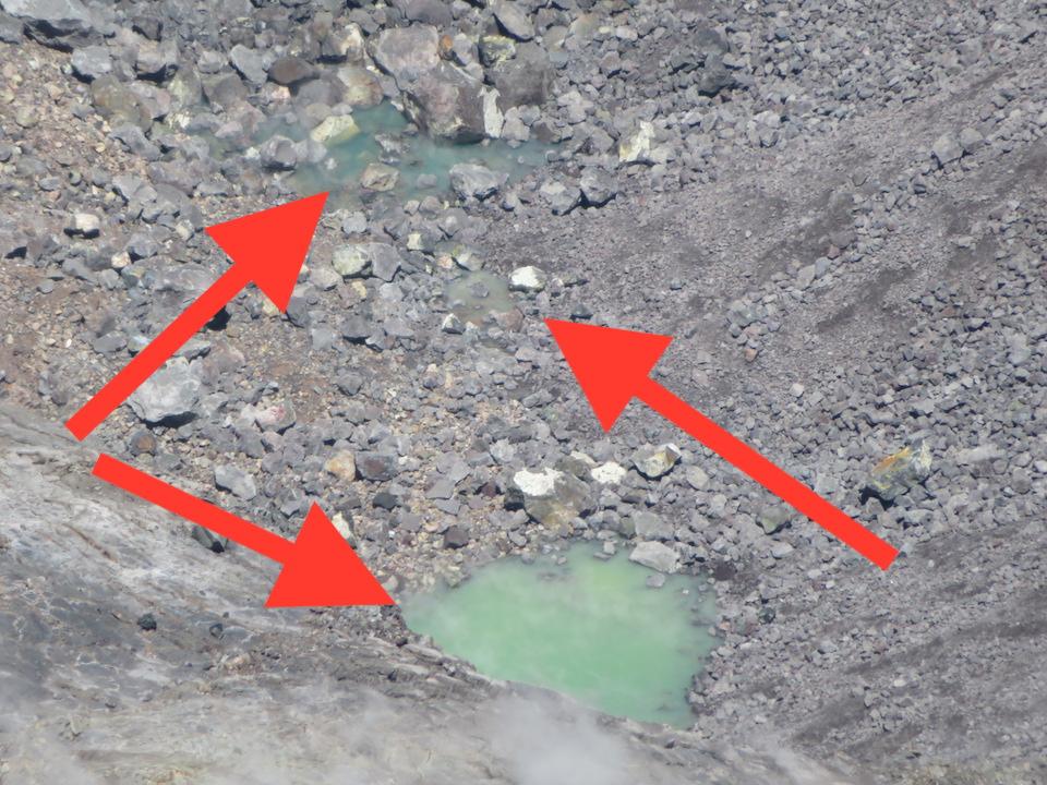 In this telephoto view of the bottom of Halema‘uma‘u, the small puddle between the two greenish ponds is more visible. USGS photo by M. Patrick