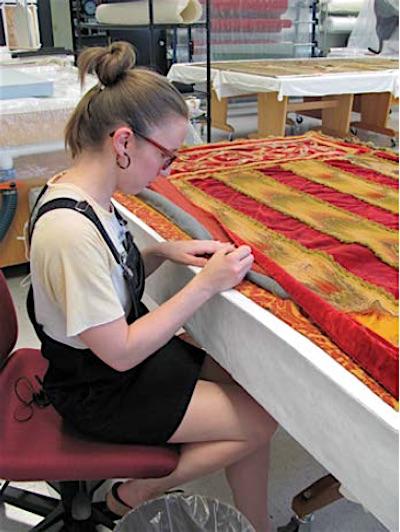 Intern Heather Hodge working to stabilize the curtains from Scotty’s Castle in Death Valley National Park / NPS photo Intern Heather Hodge working to stabilize the curtains from Scotty’s Castle in Death Valley National Park / NPS photo